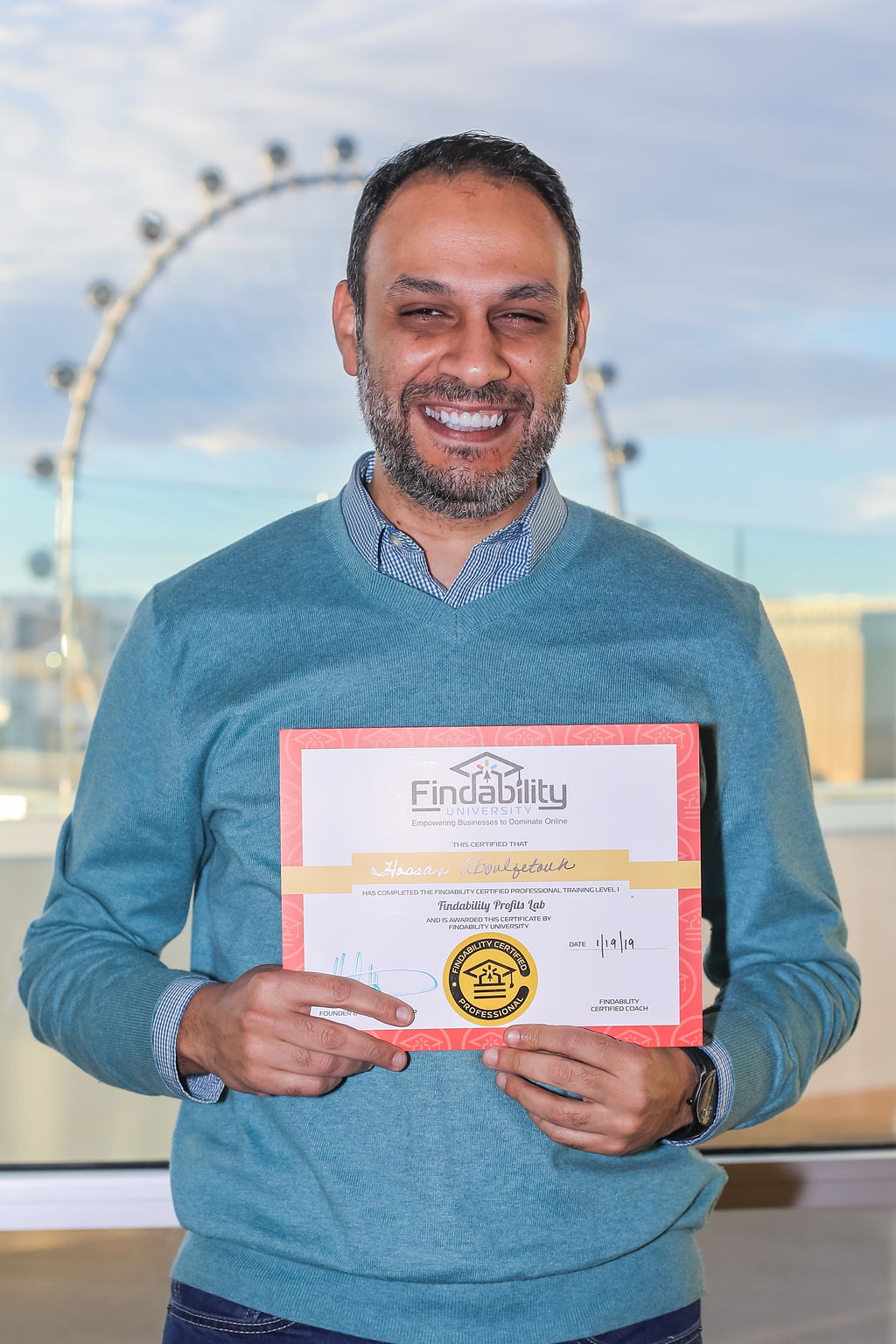 A workshop attendee holding their Findability University certificate