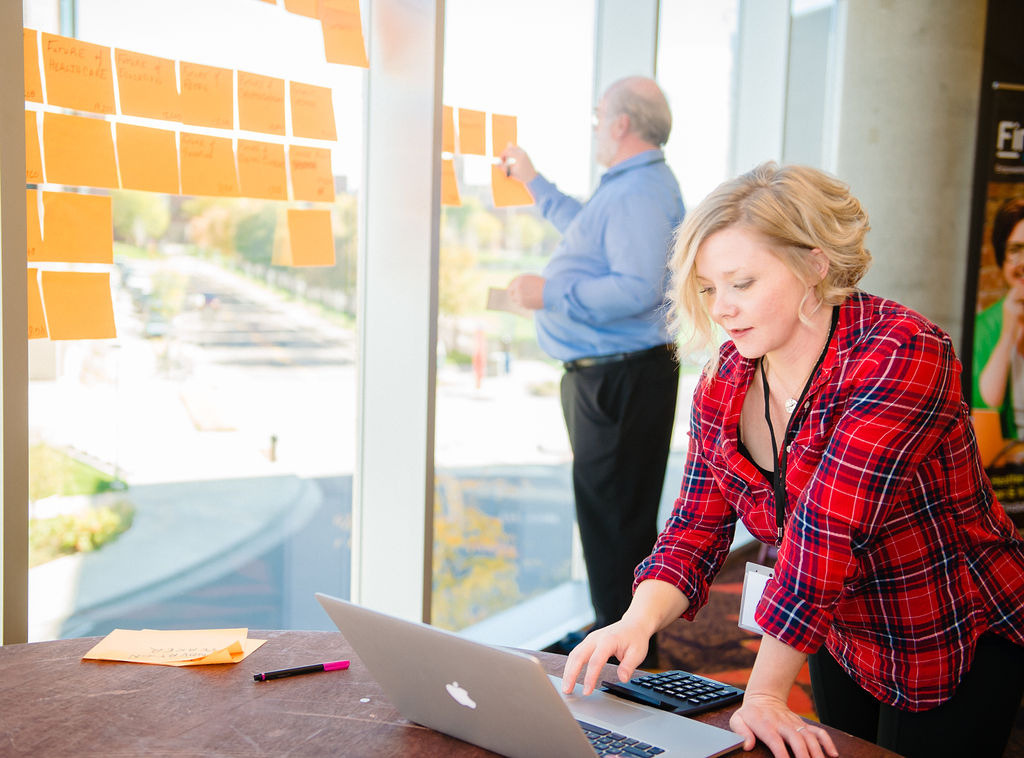 Reviewing work together at a workshop desk