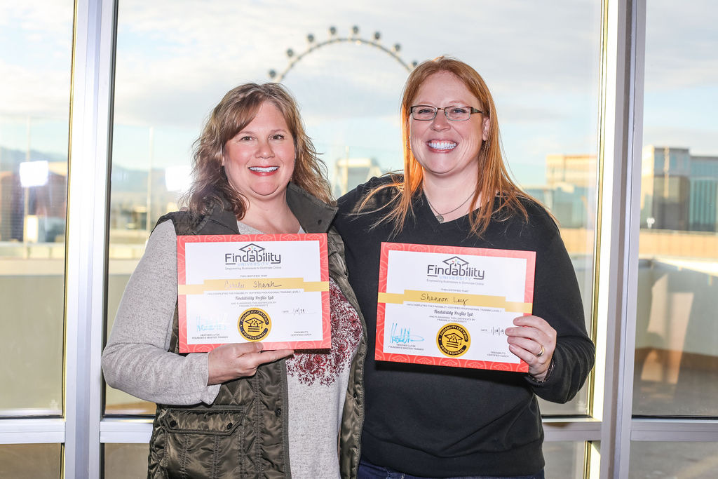 A workshop attendee holding their Findability University certificate