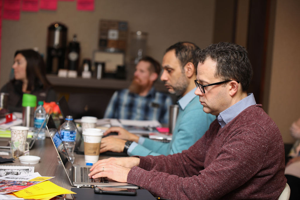 A team working together on a laptop during the workshop