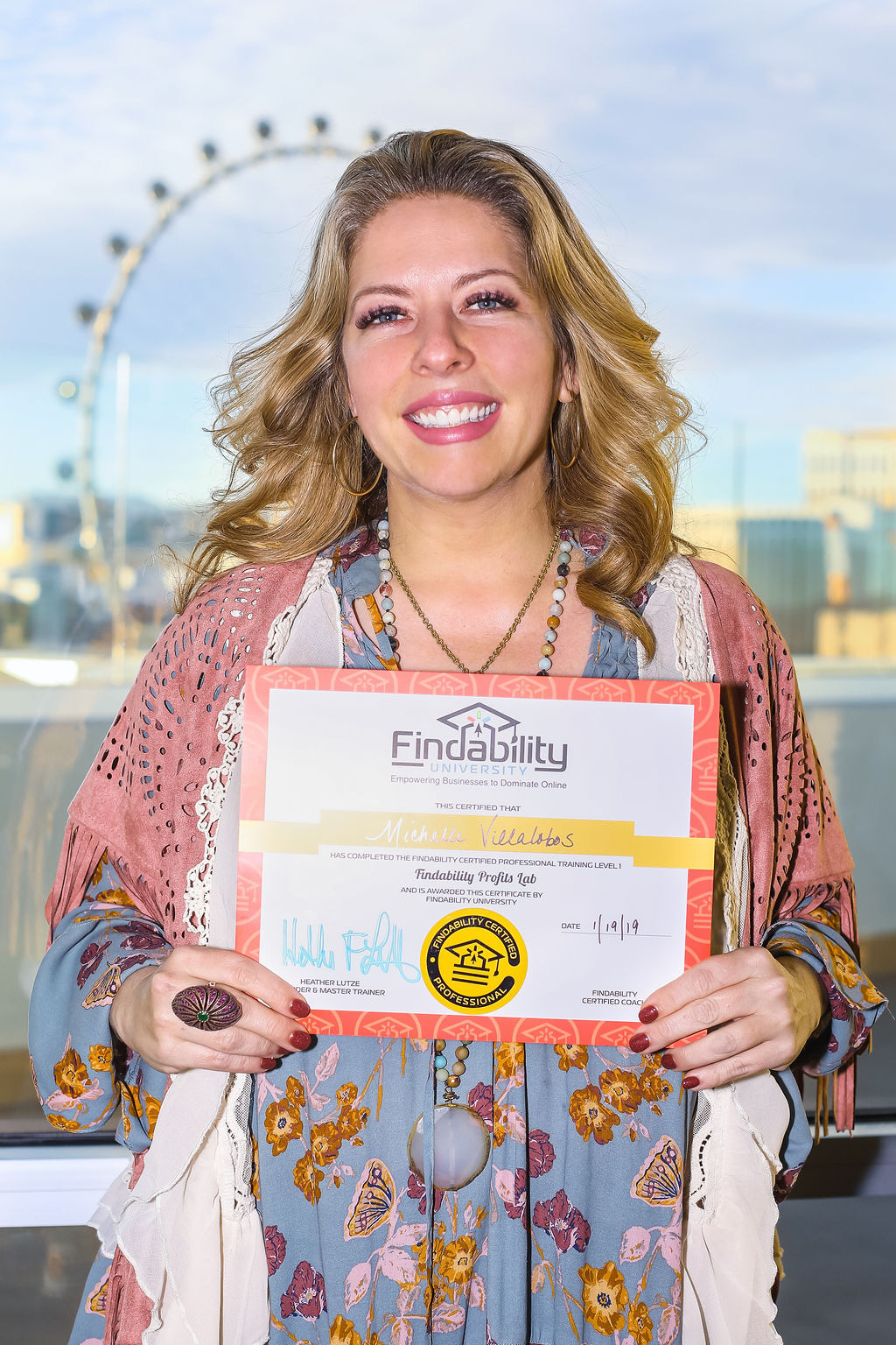 A workshop attendee holding their Findability University certificate