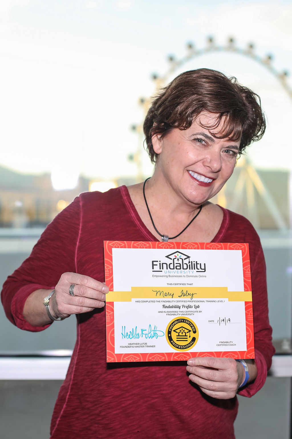 A workshop attendee holding their Findability University certificate