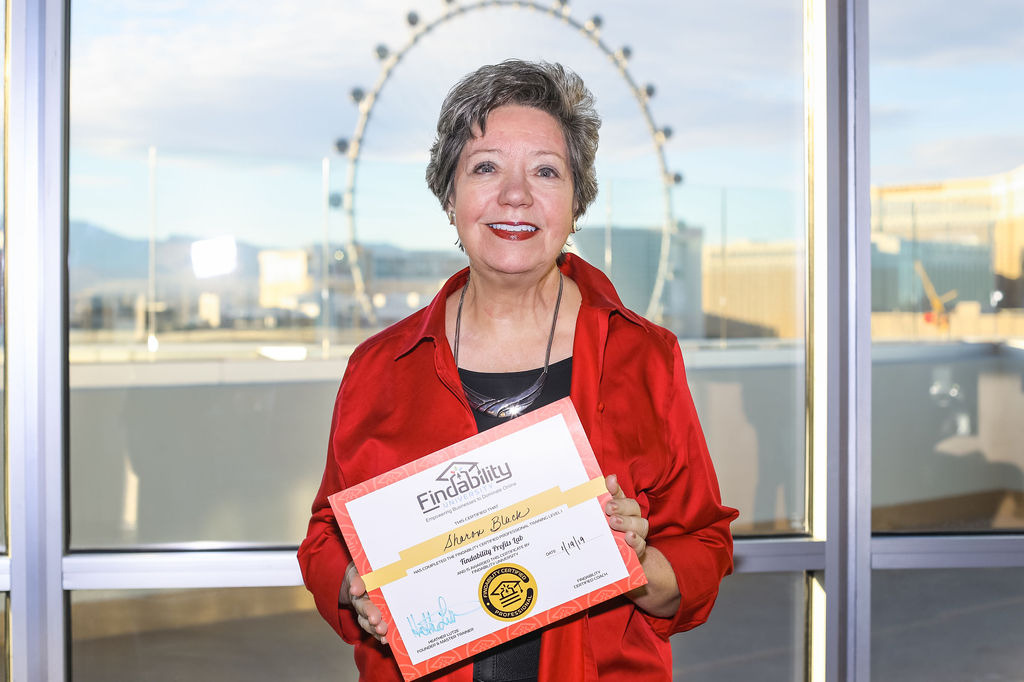 A workshop attendee holding their Findability University certificate