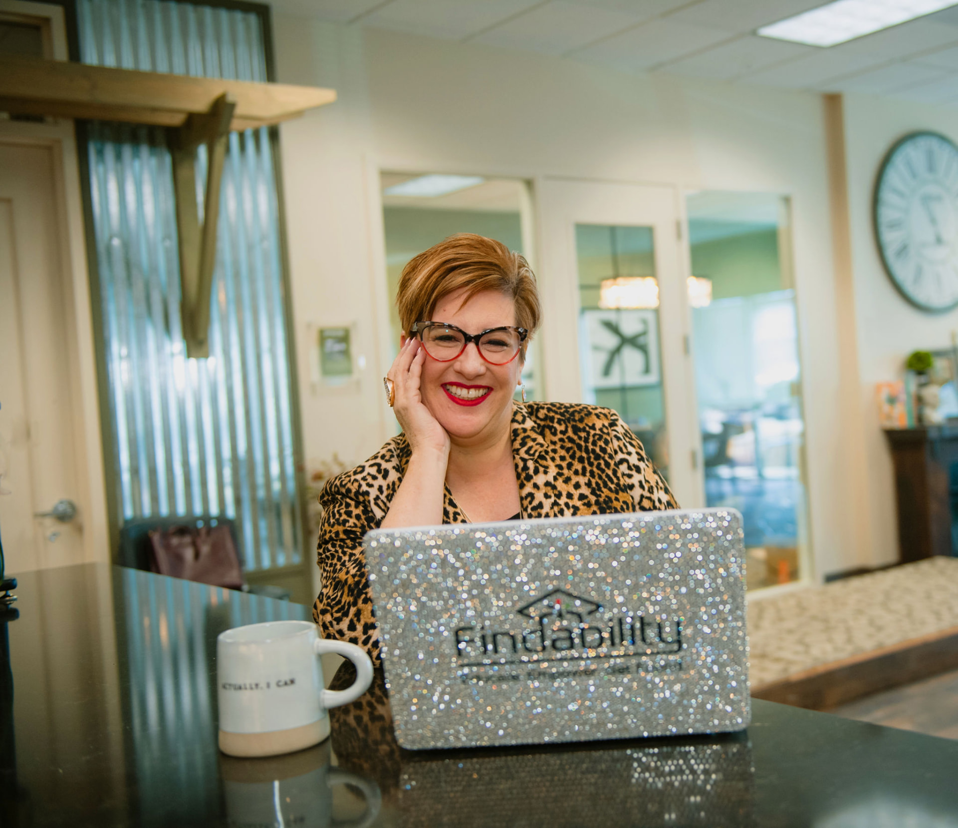 Heather Lutze smiling behind her Findability laptop