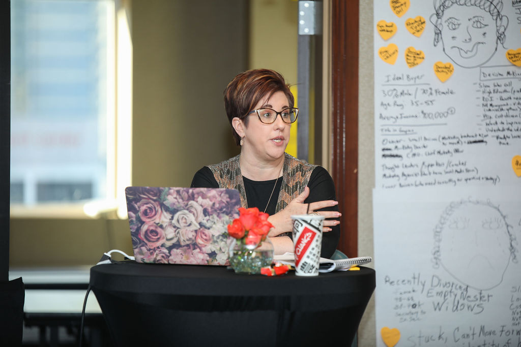 Heather Lutze teaching at the whiteboard during a workshop
