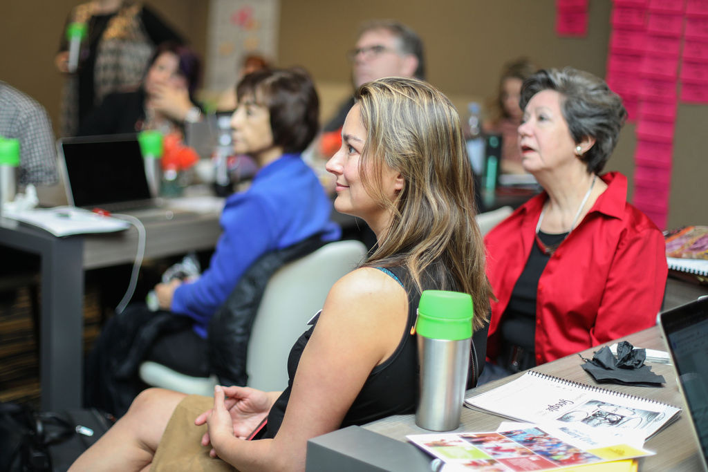 A row of workshop attendees listening during a session